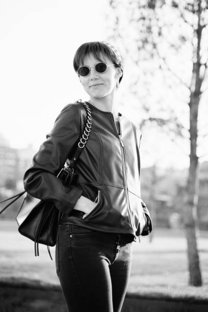 istock Young woman walking in a public park 1159343184