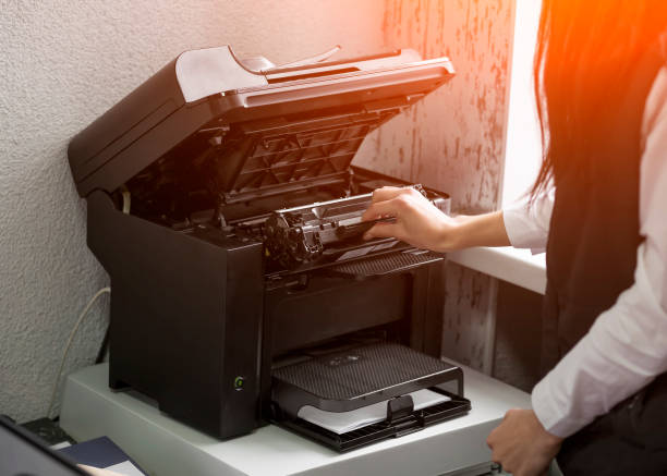 istock office worker change the cartridge in a laser printer 1159344041