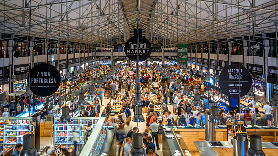 Lisbon, Portugal - October 1, 2017: People at the popular Time Out Market Lisboa, a food hall and major touristic attraction located in the Mercado da Ribeira at Cais do Sodre in Lisbon, Portugal.