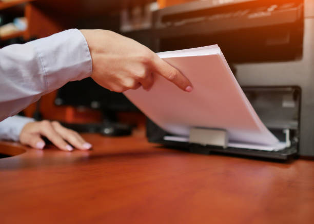istock businesswoman  working with printer in the office 1159344528
