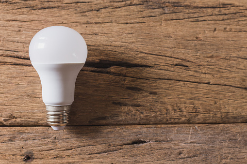 Top view of Light bulb on wooden background and copy space