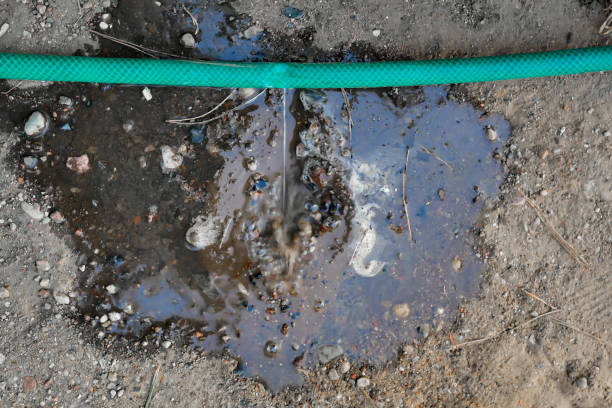 istock crack in the watering hose. Damaged hose 1159344904