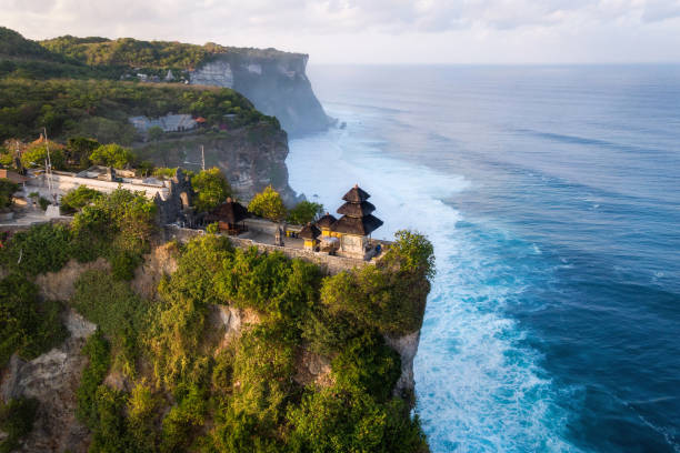 Bali, Indonesia, Aerial View of Uluwatu Temple at Sunrise Bali, Indonesia, aerial view of Pura Luhur Uluwatu temple at sunrise. uluwatu beach stock pictures, royalty-free photos & images