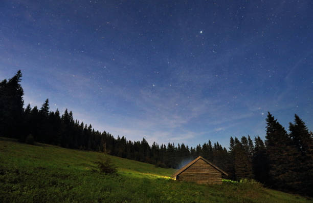 Night view of mountain stars with cottage