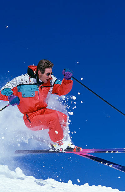 istock Snow Skier Jumping Against Blue Sky 115934739