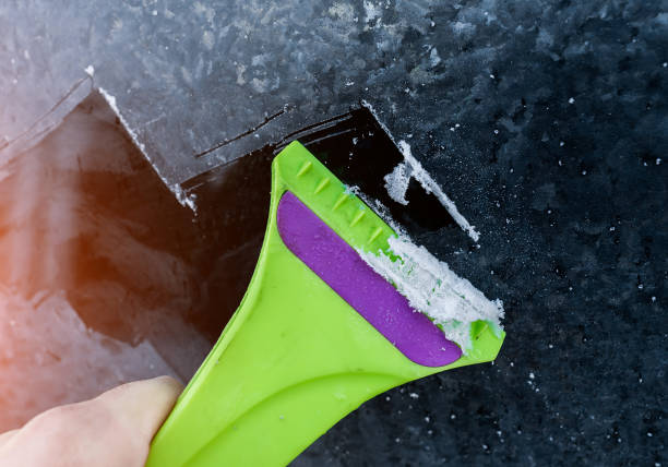 istock Cleaning frozen car window from the ice 1159347673