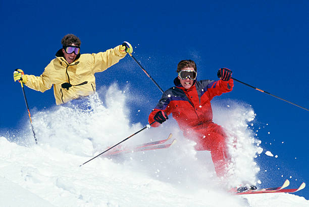 istock Two Snow Skiers Blasting Through Fresh Powder 115934866