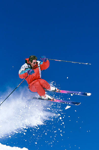 istock Snow Skier Jumping Against Blue Sky 115934868