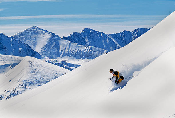 Snow Skier Making First Tracks with Mountain View stock photo