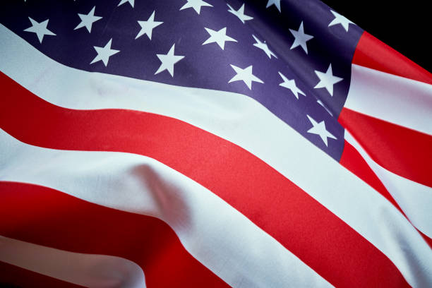 istock US flag waving in wind on Independence Day in America 1159350263