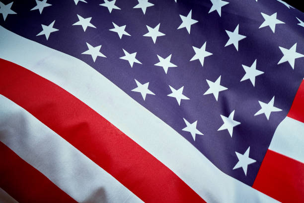 istock US flag waving in wind on Independence Day in America 1159350464