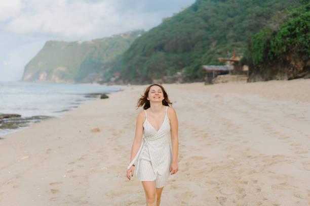 istock Woman walking on  beach on Bali 1159351814