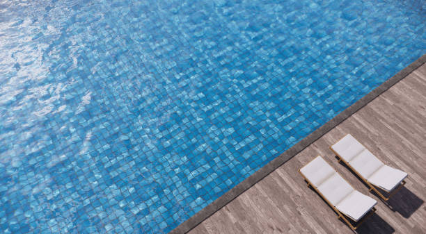 istock Two daybeds on wood deck side swimming pool. 3D illustration 1159354940