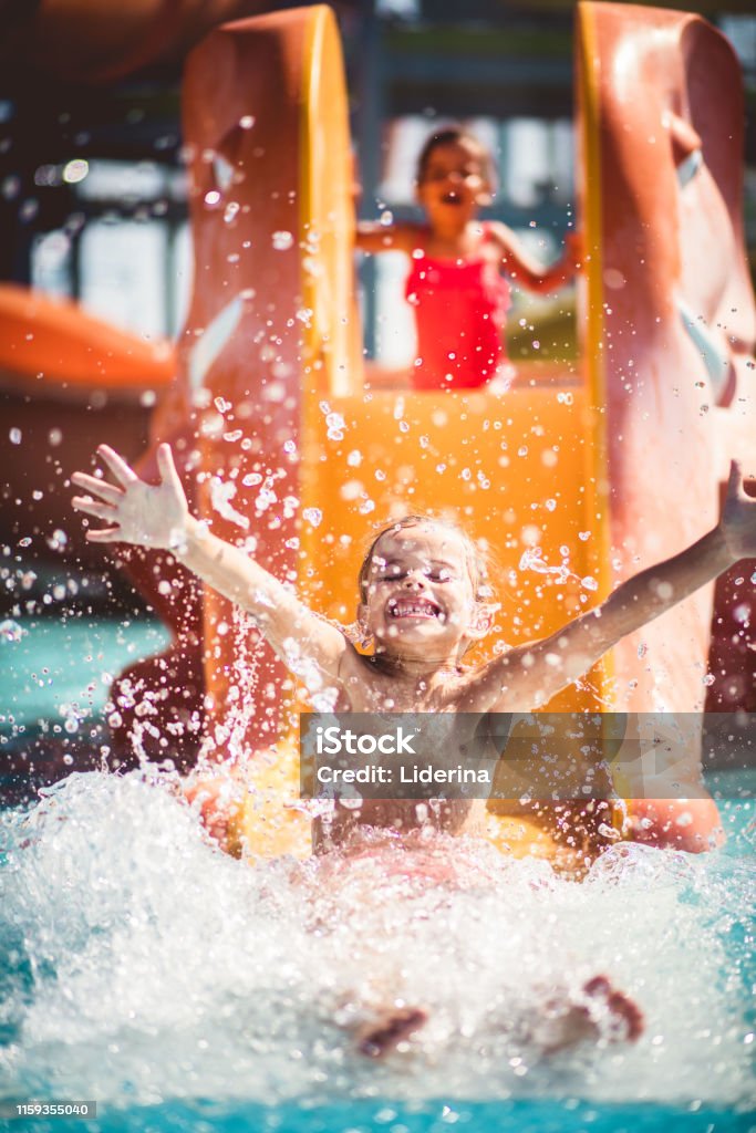 Whoopee! Whoopee! Children in pool. Vacations Stock Photo