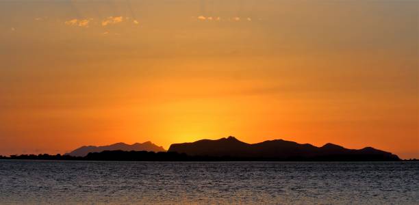 istock sunset over the sea with promontory in the background 1159356364