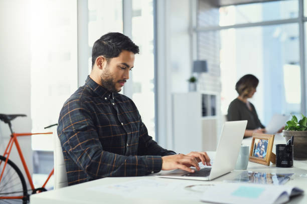 istock Sending out a few emails to his clients 1159356600