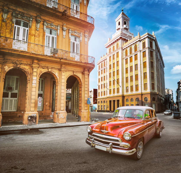istock Vintage orange oldtimer car driving through Old Havana Cuba 1159357316