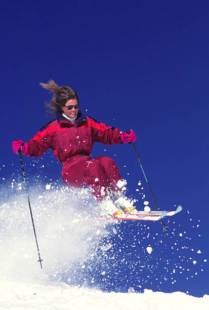 istock Woman Jumping on Snow Skis 115935998