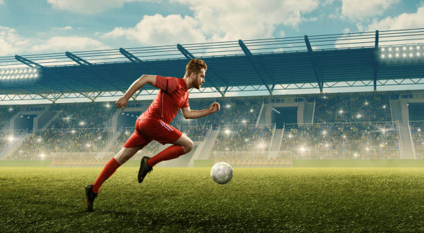 istock Soccer player dribbles a ball on a stadium 1159360426