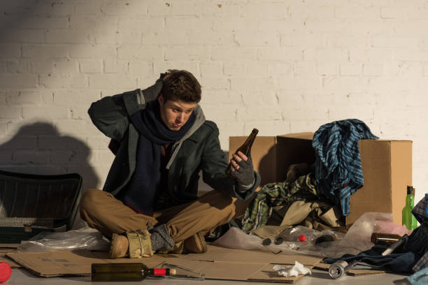 istock disappointed homeless man holding empty alcohol bottle 1159360512