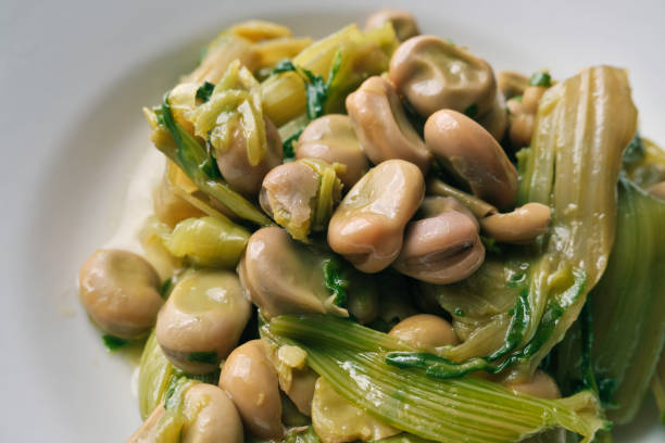recipe of vegetables of the Apulian culture. boiled beans and vegetables seasoned with olive oil ready to eat. broad bean plant stock pictures, royalty-free photos & images