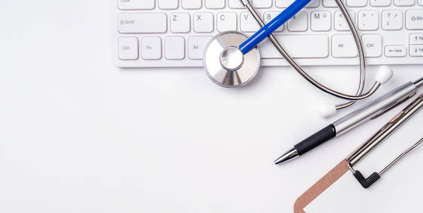 istock Stethoscope on computer keyboard on white background. Physician write medical case long term care treatment concept, top view, flat lay, copy space 1159364737