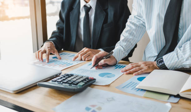 istock Business people working together at office room table and balancing budget. 1159364752