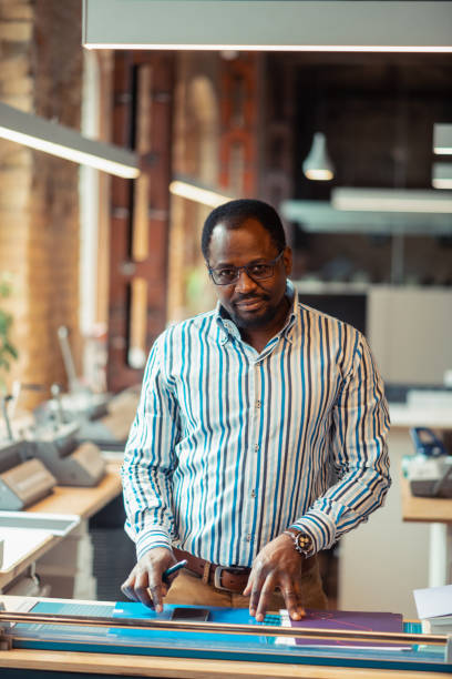 istock Dark-skinned man making some measurements before printing 1159365493