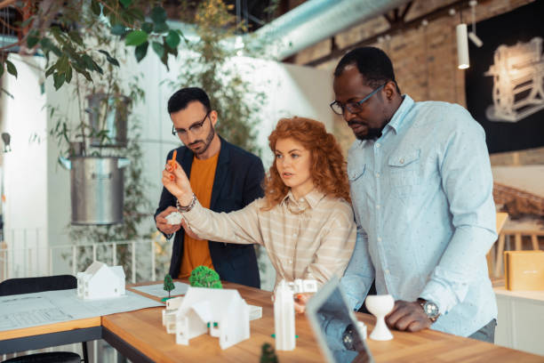istock Three interior designers working on green city project together 1159365539