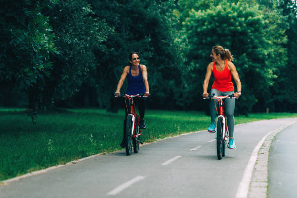 istock Women Riding Bicycles Together 1159366732