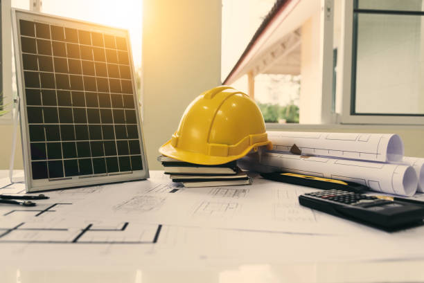 istock Desk of architects Solar Energy Powered Home Green for reduce global warming. 1159366871