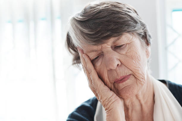 istock Senior woman, head on hand, either sleeping or sad 1159366984