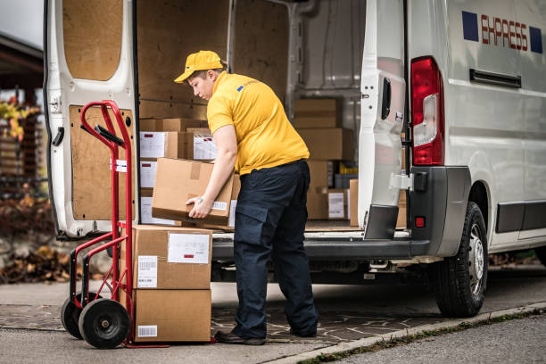 istock Delivery woman stacking packages on cart 1159367028