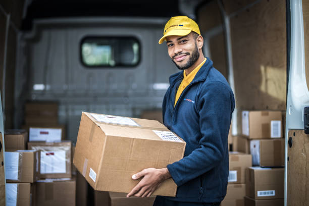 Delivery man holding parcel stock photo