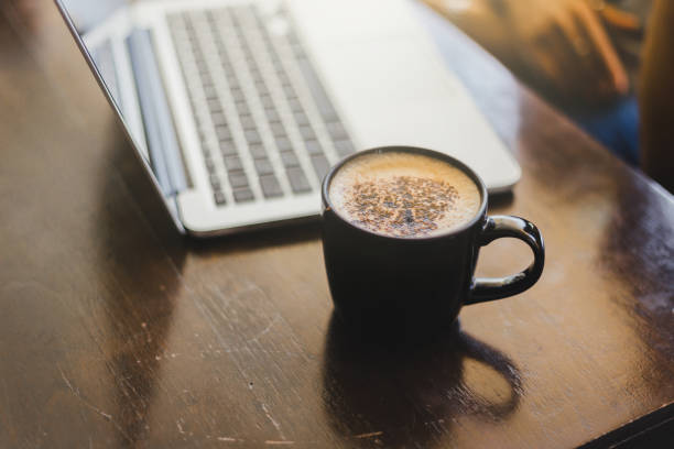 istock Laptop and coffee cup at his working place in Cafe. 1159367186