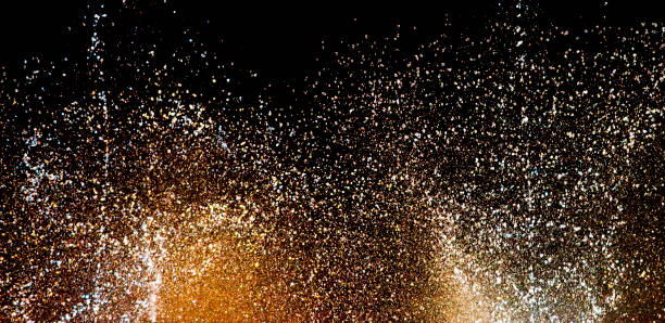 istock Abstract golden sparkle against black background. 1159369932