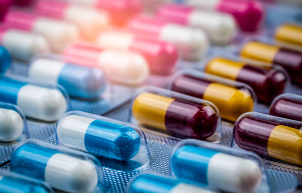 istock Selective focus on blue-white capsule pills in blister pack. Pharmaceutical industry. Drug package. Pharmaceutics concept. Drug use in hospital or drugstore product. Health budget. Global healthcare. 1159370375