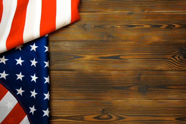 istock American flag on a old wooden desk top view - Image 1159370802