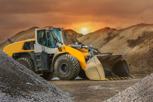 istock Excavator in a construction site, surrounded by stone and rock 1159371761