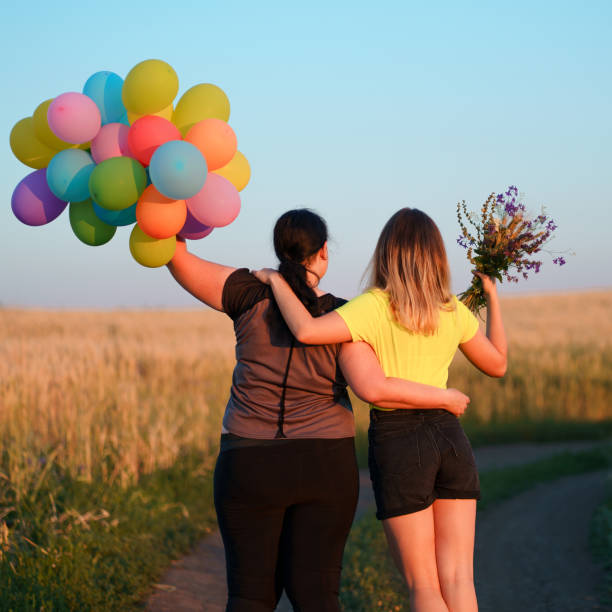 istock Two young best friends walking down a country road 1159372487