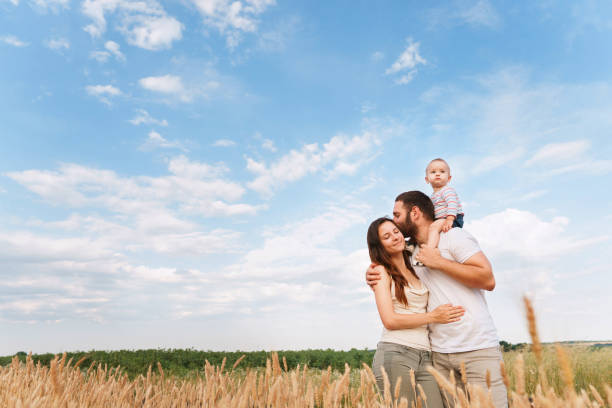 istock parents walking outdoors hugging baby son 1159372561