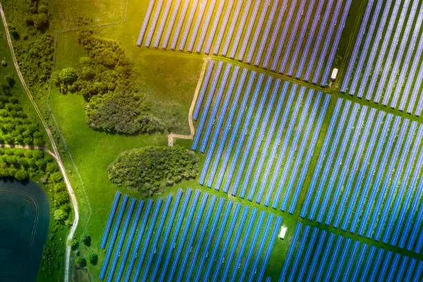 Aerial view over Solar cells energy farm in countryside landscape