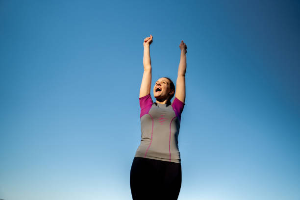 istock Cheerful Young Woman Celebrating Running Achievement 1159374314
