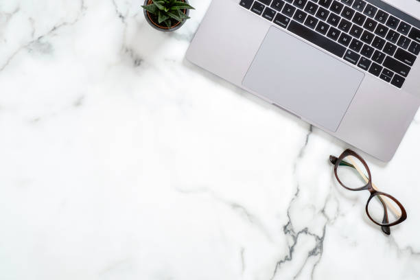istock Marble office desk table with laptop computer, glasses, succulent plant. Minimal flat lay style composition, top view, overhead. Business woman workspace concept. 1159376139