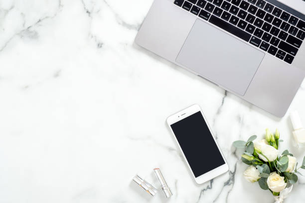 istock Flat lay home office desk. Female workspace with laptop computer, blank screen smartphone, flowers bouquet, cosmetic. Top view feminine background. Fashion blogger workspace concept. 1159376169