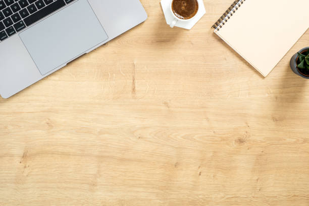 istock Modern wooden office desk table with laptop computer, paper notepad, succulent plant, coffee cup. Top view with copy space, flat lay. Feminine workspace concept. 1159376183