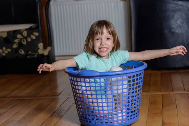 istock A girl in a laundry basket. 1159376210