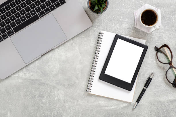 istock Office desk table with laptop computer, blank copy space mockup screen tablet, succulent plant, cup of coffee, glasses and supplies. Top view with copy space, flat lay. Feminine workspace concept. 1159376225