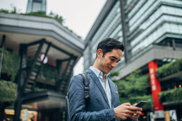istock Businessman using smart phone downtown Taipei 1159376312