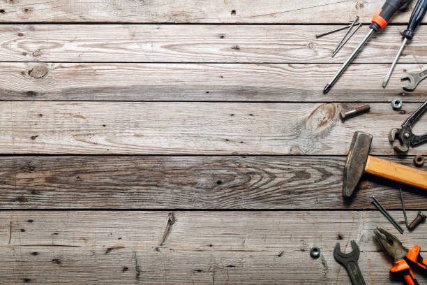 istock Flat lay composition with vintage carpentry tools on rough wooden background. Top view workbench with carpenter different tools. Woodworking, craftsmanship and handwork concept. 1159376746